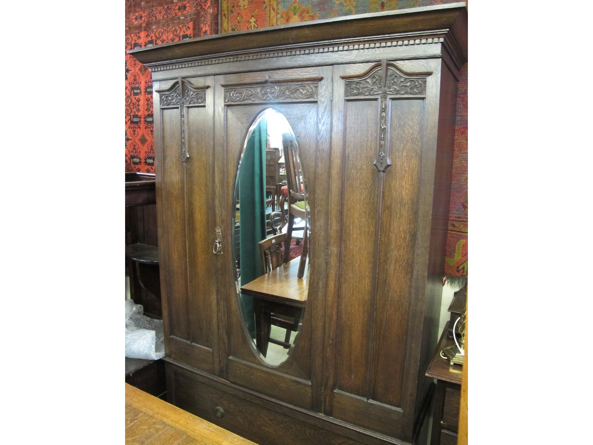 Appraisal: An oak dressing table and mirrored wardrobe