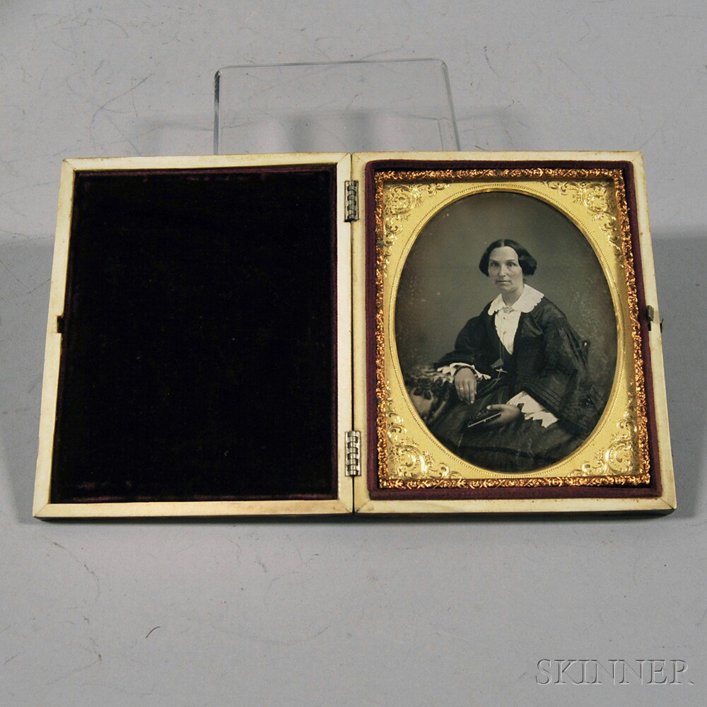 Appraisal: Quarter-plate Daguerreotype Portrait of a Woman Holding a Cased Photograph