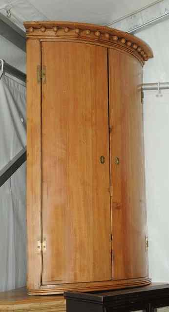 Appraisal: AN ANTIQUE PINE BOW FRONTED HANGING CORNER CUPBOARD wide x