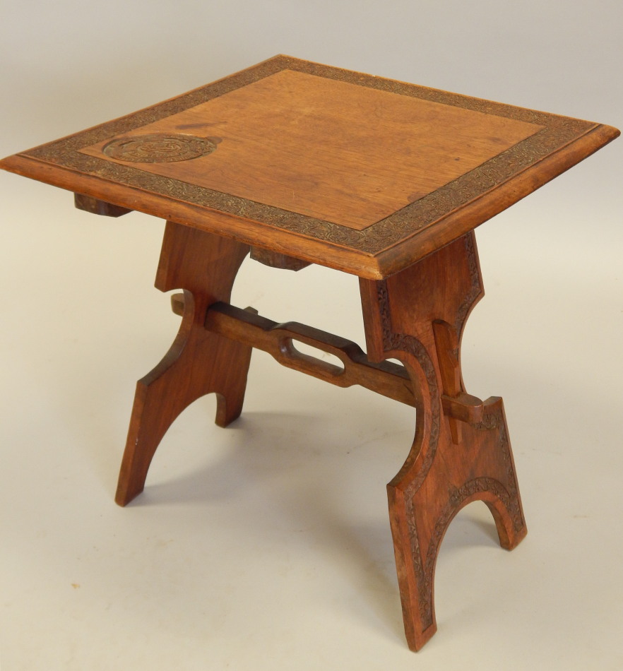 Appraisal: An Eastern hardwood occasional table the square top carved with