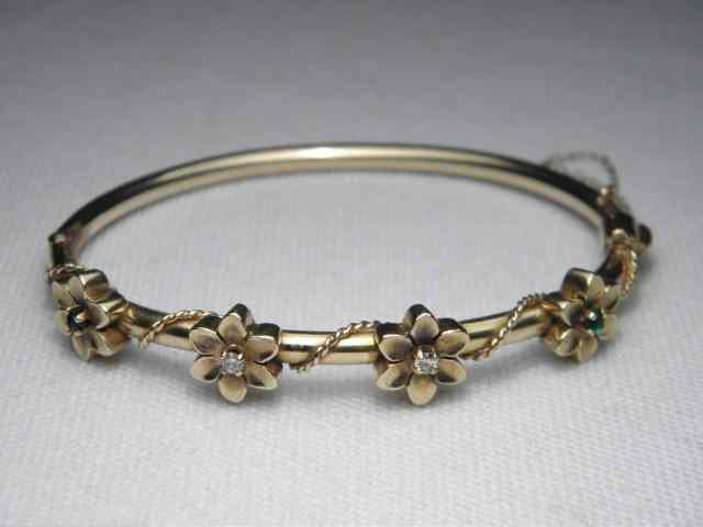 Appraisal: A kt yellow gold bangle bracelet with four applied kt