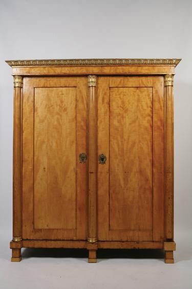 Appraisal: A BIEDERMIER SATIN BIRCH ARMOIRE the shaped cornice with carved