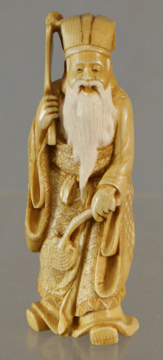 Appraisal: Carved ivory figure of an elder man with paddle and