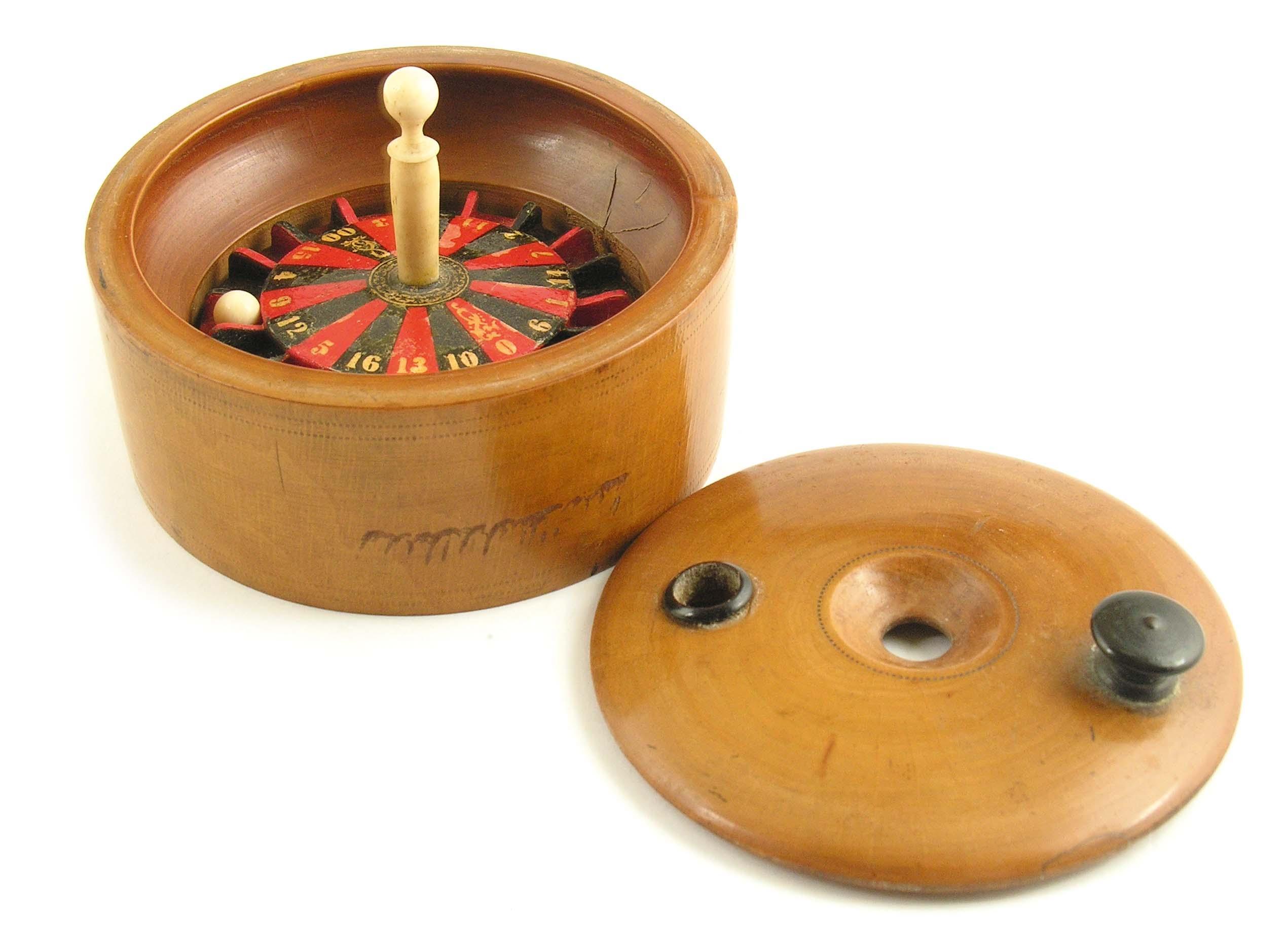 Appraisal: A turned boxwood miniature cased roulette wheel