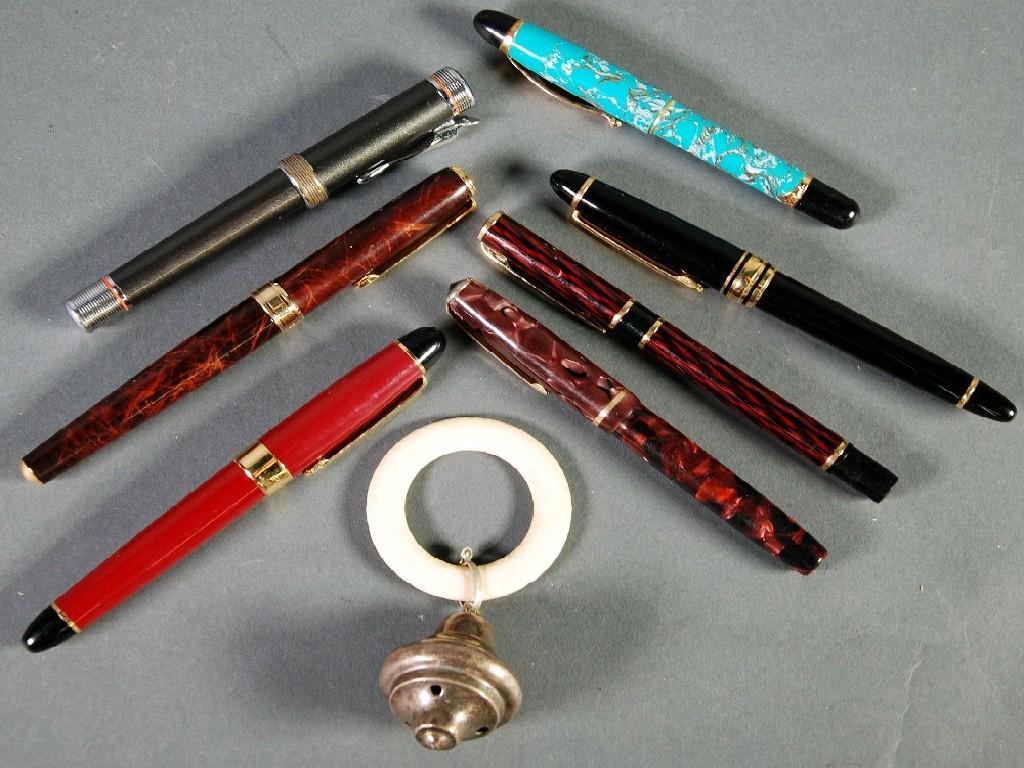 Appraisal: SEVEN FOUNTAIN PENS AND A WHITE METAL INFANTS LEATHER RATTLE