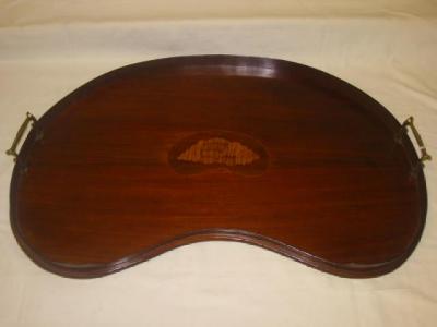 Appraisal: AN EDWARDIAN MAHOGANY TEA TRAY of kidney form with central