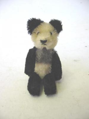 Appraisal: A Schuco miniature panda covered in black and cream plush