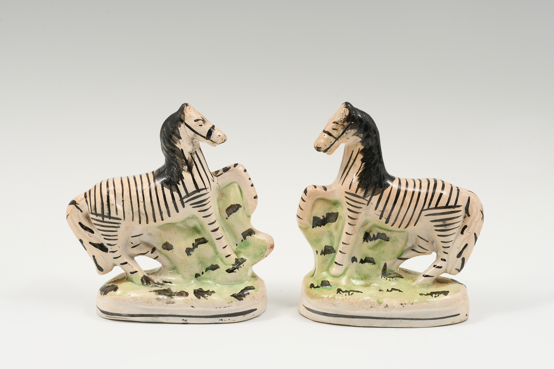 Appraisal: PAIR ENGLISH STAFFORDSHIRE POTTERY ZEBRAS Two opposing th-century Staffordshire Zebra