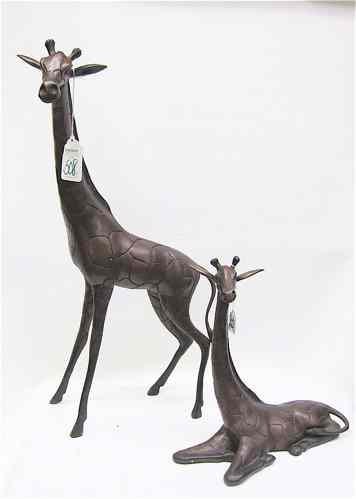 Appraisal: TWO BRONZE WILDLIFE SCULPTURES two African giraffe standing and recumbent