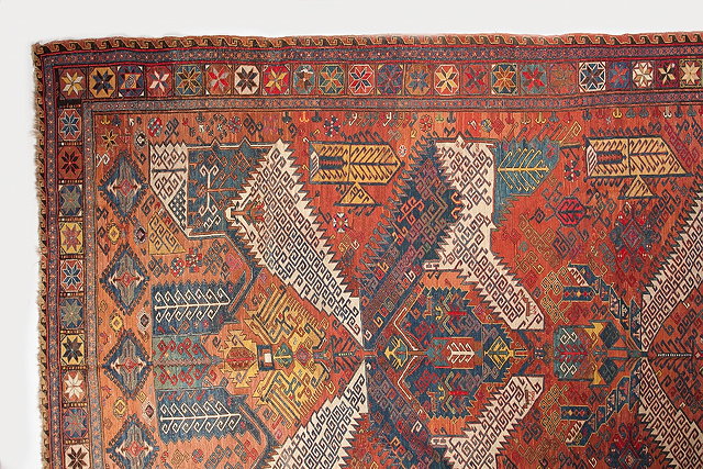 Appraisal: AN ANTIQUE SOUMAK CARPET with a polychrome interlinked hooked medallion