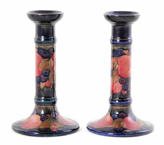 Appraisal: Pair Moorcroft candlesticks early th century Pomegranate design stamped Moorcroft