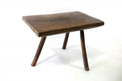 Appraisal: A primitive three-legged stool table the top cm x cm