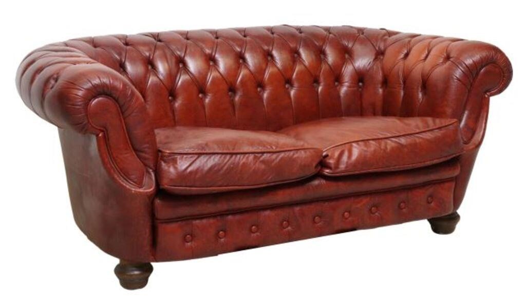 Appraisal: Chesterfield style two-seat sofa th c in distressed burgundy leather