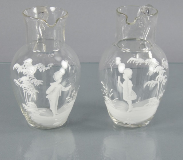 Appraisal: Two Clear Glass Mary Gregory PitchersOne decorated with enamel scene