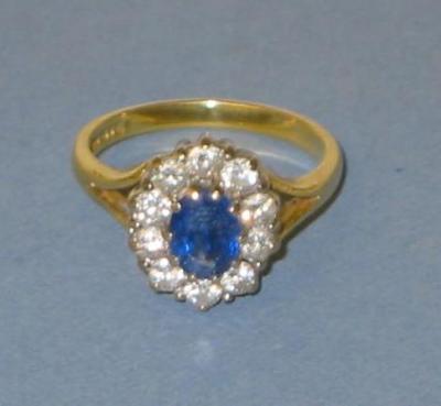 Appraisal: A SAPPHIRE AND DIAMOND CLUSTER RING the oval cut sapphire