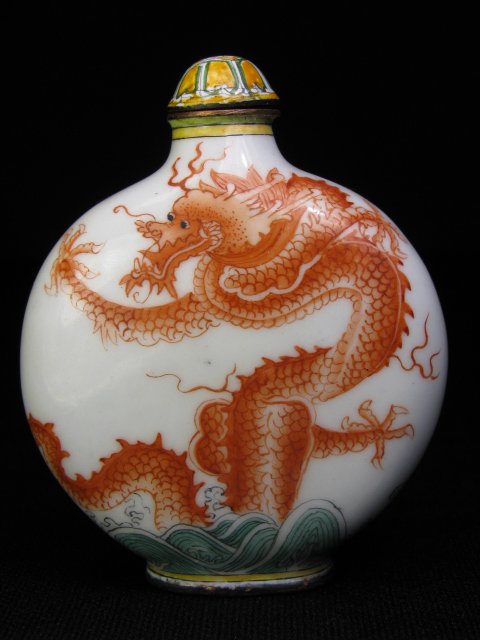 Appraisal: Chinese Beijing enamel snuff bottle with a red dragon emerging