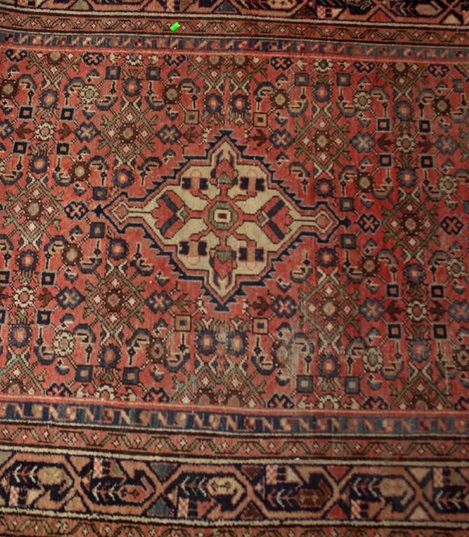 Appraisal: HAMADAN RUG the deep pink ground centred by an ivory