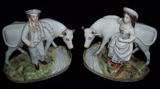 Appraisal: A pair of Staffordshire pottery figures cowherd and milkmaid cm