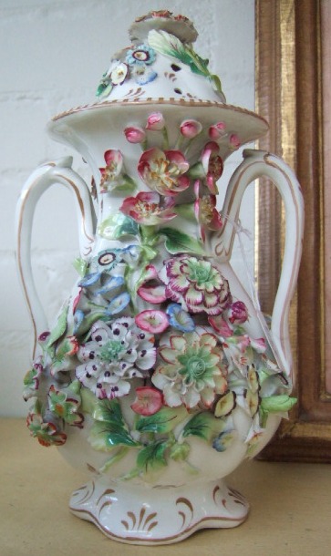 Appraisal: An English porcelain floral encrusted vase probably Coalbrookdale twin handles