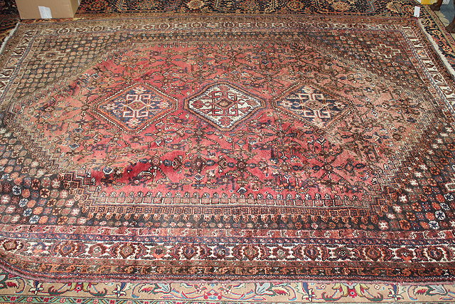 Appraisal: A LARGE BROWN GROUND SHIRAZ RUG with triple medallion design