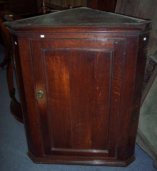 Appraisal: An early th Century oak corner cupboard with moulded cornice