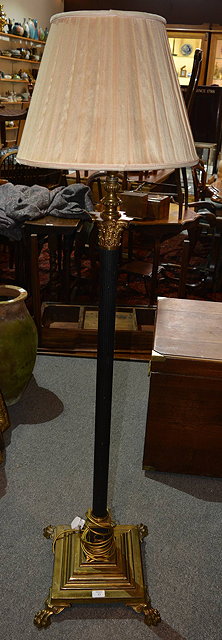 Appraisal: A brass and painted column standard lampwith stepped square base