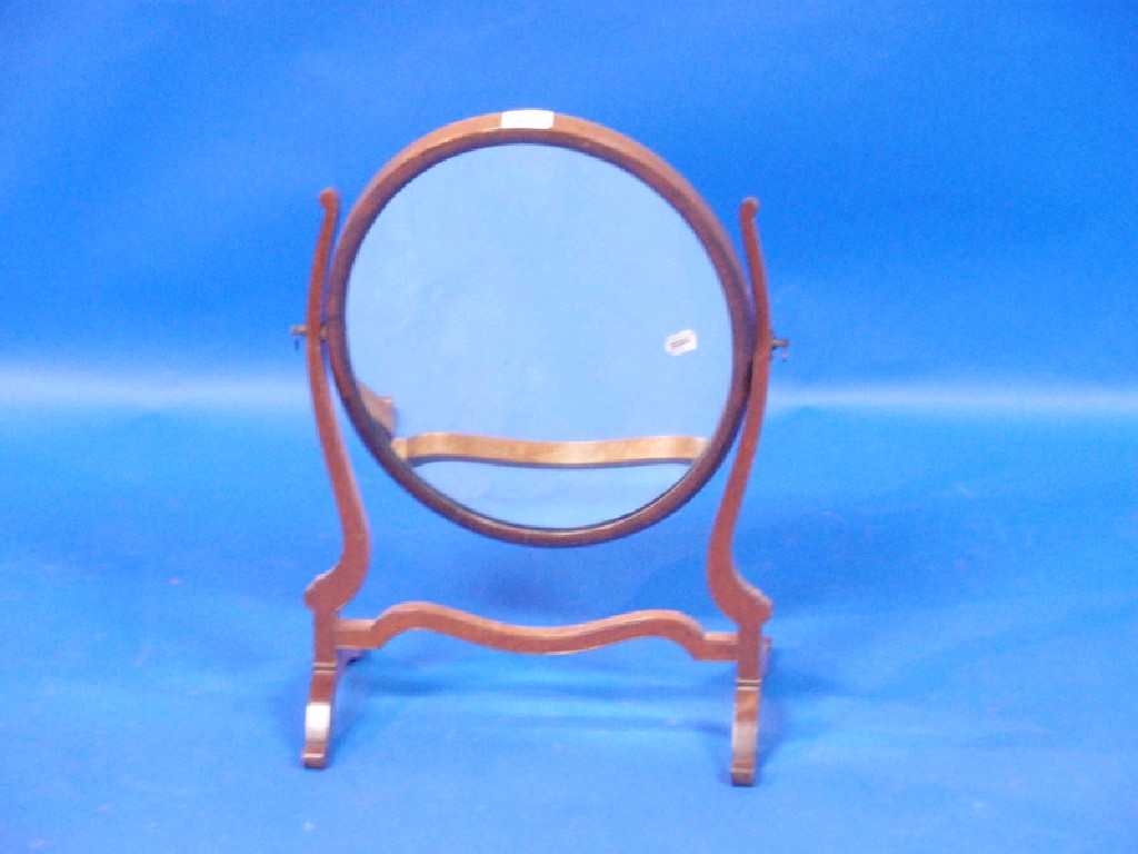 Appraisal: A Georgian style oval mahogany toilet mirror with scroll shape