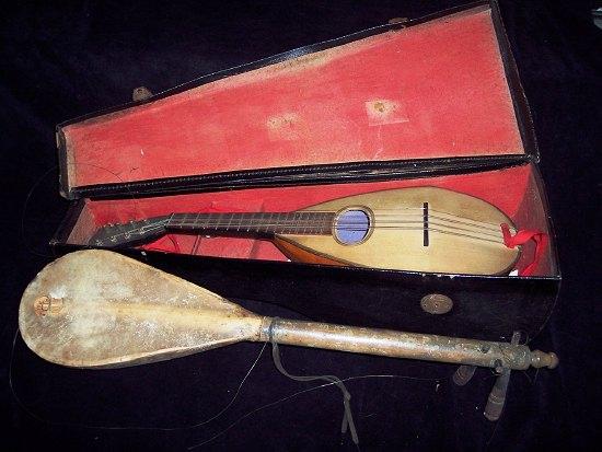 Appraisal: A cased mandolin cm long and a similar hide covered