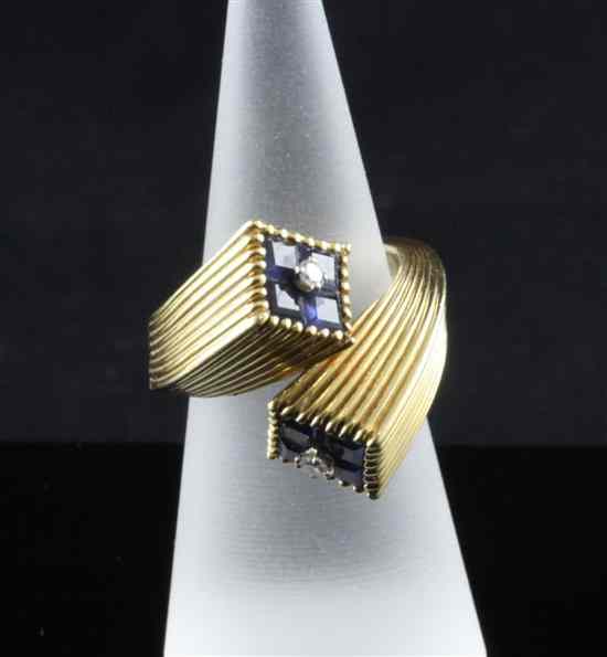 Appraisal: A stylish sapphire and diamond set crossover ring of reeded