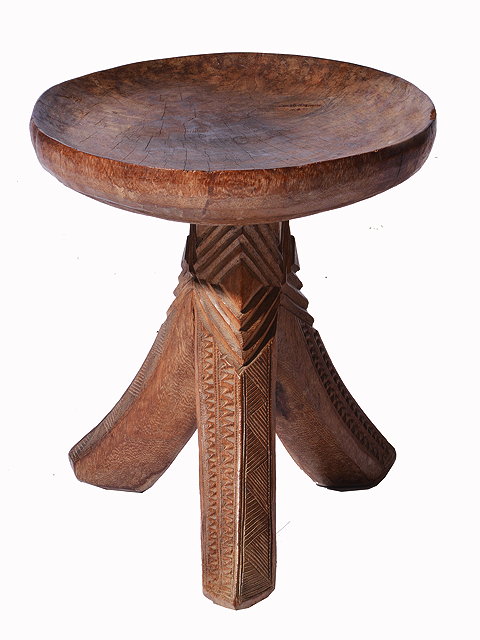 Appraisal: A CAMEROONIAN CARVED WOODEN DISHED TOPPED STOOL on tripod base