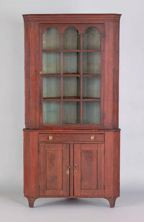 Appraisal: Pennsylvania stained poplar two part corner cupboard early th c