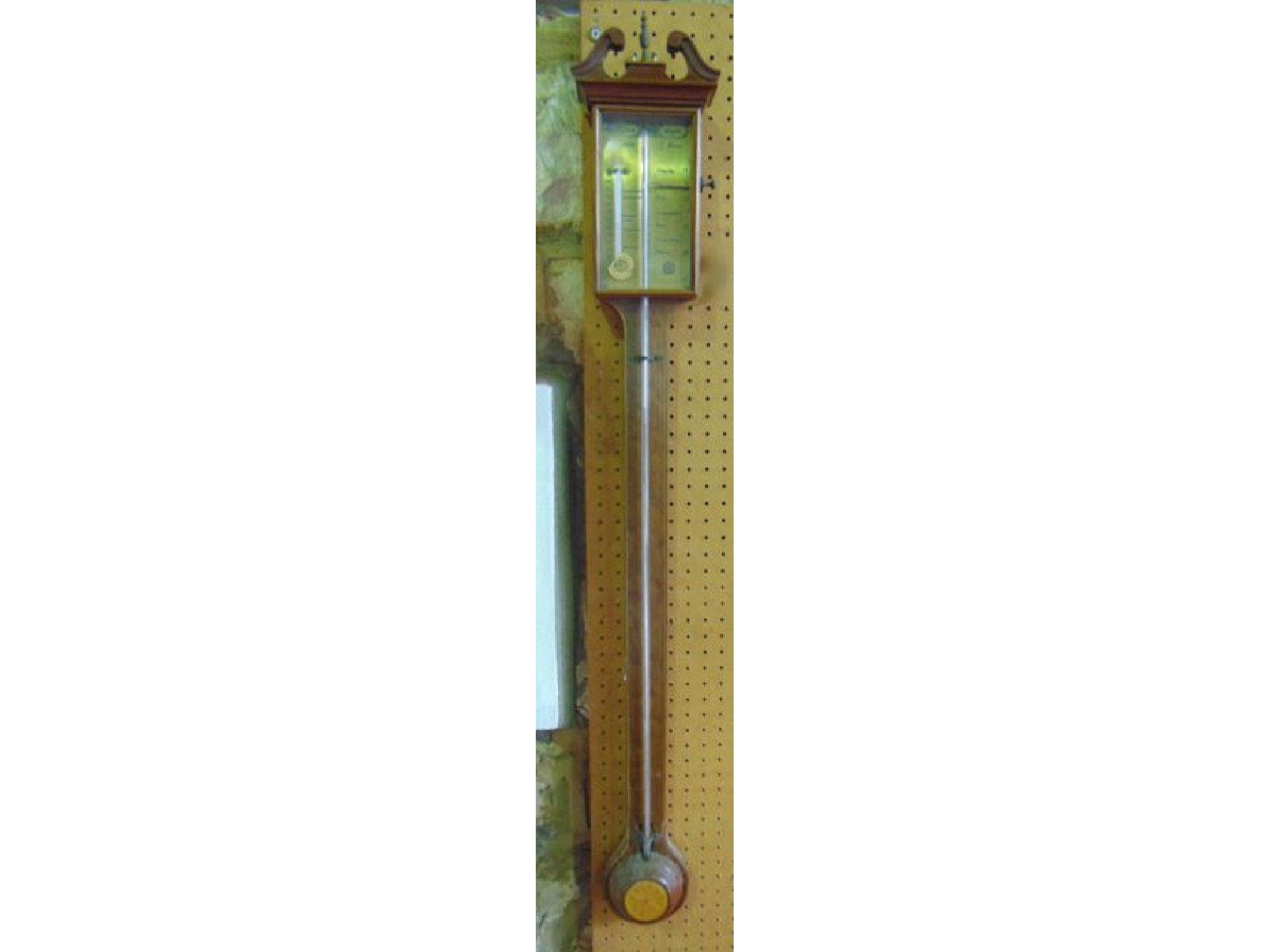 Appraisal: A reproduction mahogany stick barometer with brass dial string banded