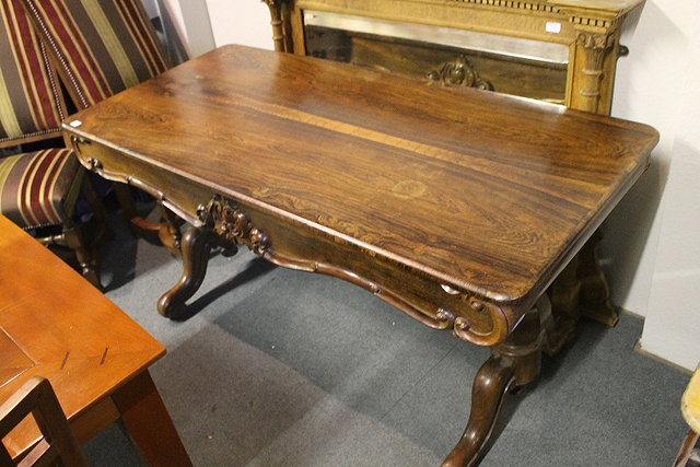 Appraisal: A VICTORIAN ROSEWOOD LIBRARY TABLE with rectangular top and scrolled