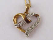 Appraisal: A yellow metal tests carat gold diamond heart pendant with