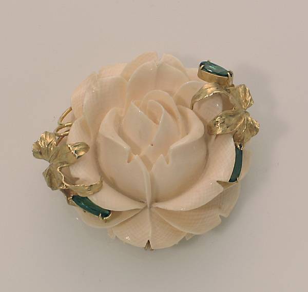 Appraisal: An ivory green tourmaline and k gold flower brooch