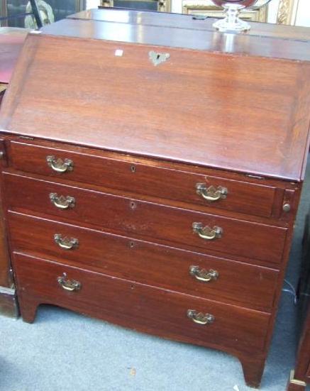 Appraisal: A George III oak bureau the fall enclosing a fitted