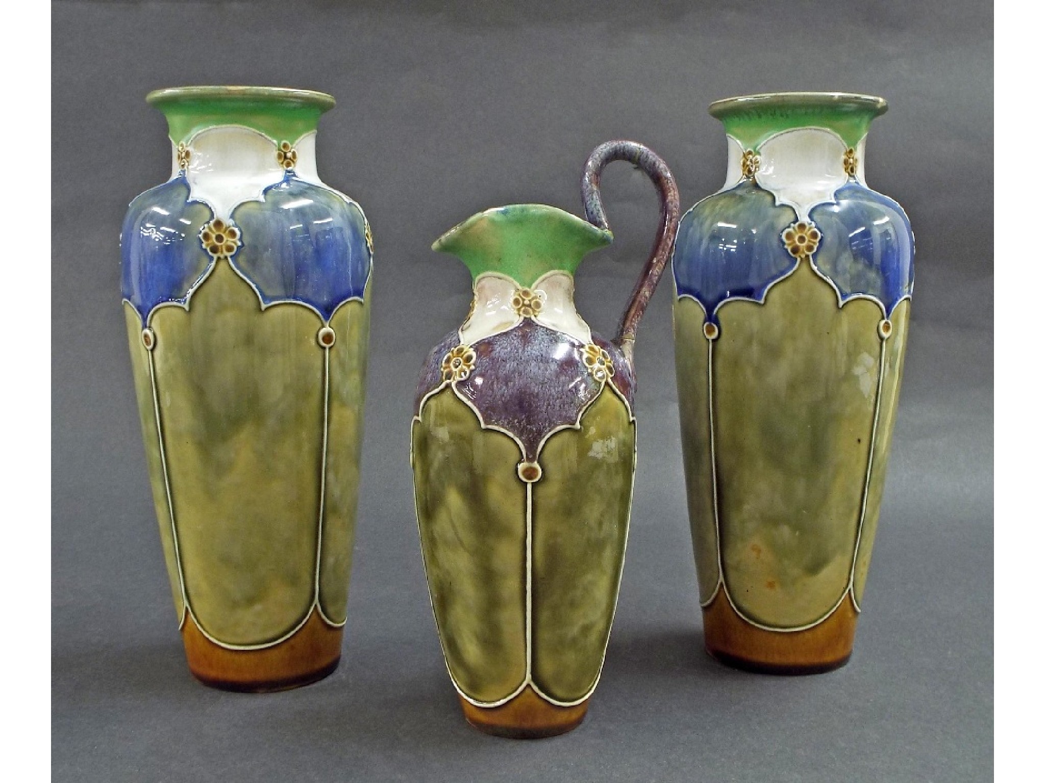 Appraisal: Royal Doulton Lambeth three piece garniture comprising two baluster vases