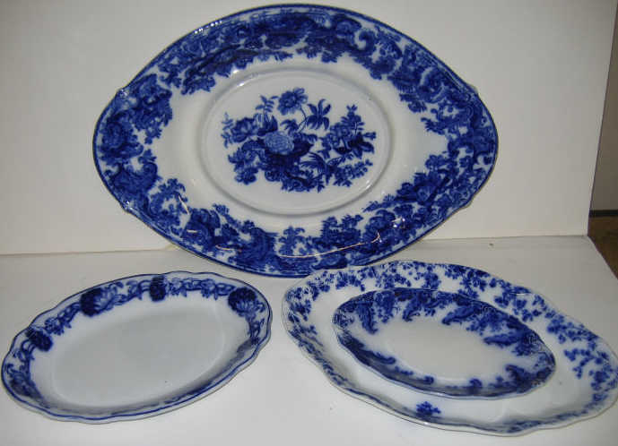 Appraisal: FOUR ENGLISH FLOW BLUE POTTERY PLATTERS Each oval comprising Copeland