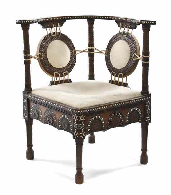 Appraisal: A Carlo Bugatti Walnut Corner Chair with a curved crest