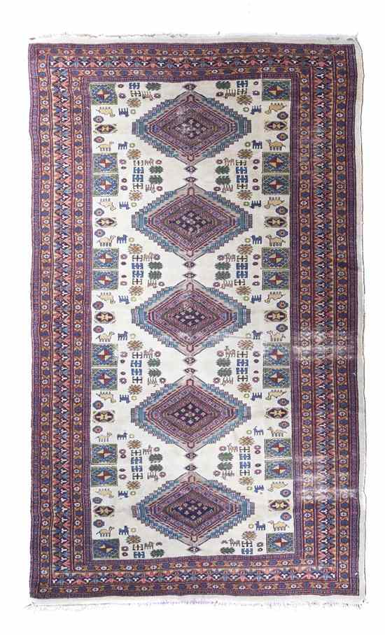 Appraisal: A Persian Wool Rug having five geometric lozenges on an