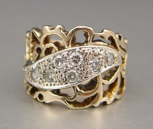 Appraisal: FILIGREE GOLD BAND RING WITH DIAMONDS K yellow gold ring