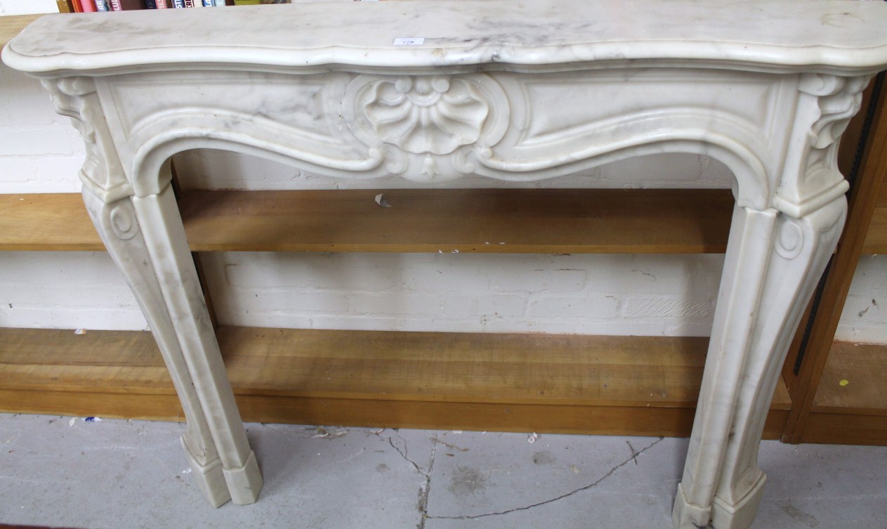 Appraisal: A thC style French marble finish fire surround the serpentine