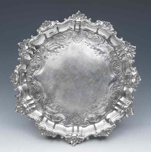 Appraisal: A GEORGE II SILVER WAITER with scroll and shell border