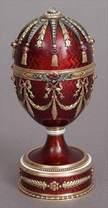 Appraisal: RUSSIAN RUBY-MOUNTED ENAMEL EGG Applied with tassled rays pendant husks