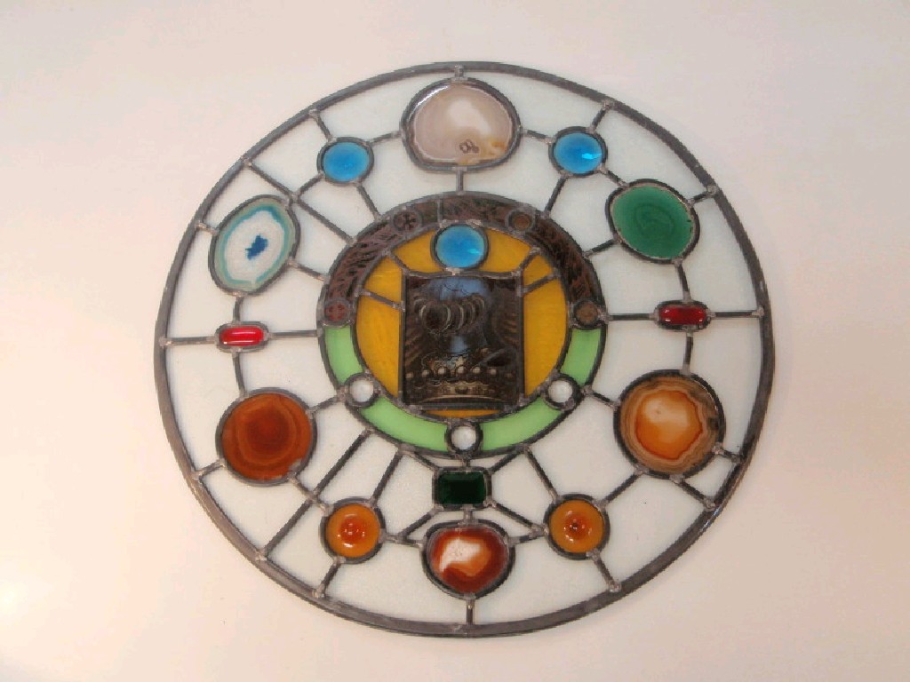 Appraisal: A circular stained glass panel with central armorial and agates