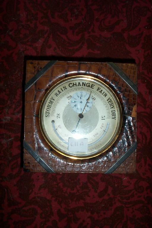 Appraisal: An Edwardian desktop barometer in a brass case incorporating a