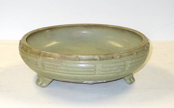 Appraisal: A celadon glazed ceramic footed basin Raised on three animal