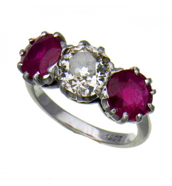 Appraisal: A RUBY AND DIAMOND THREE-STONE RING the round brilliant cut