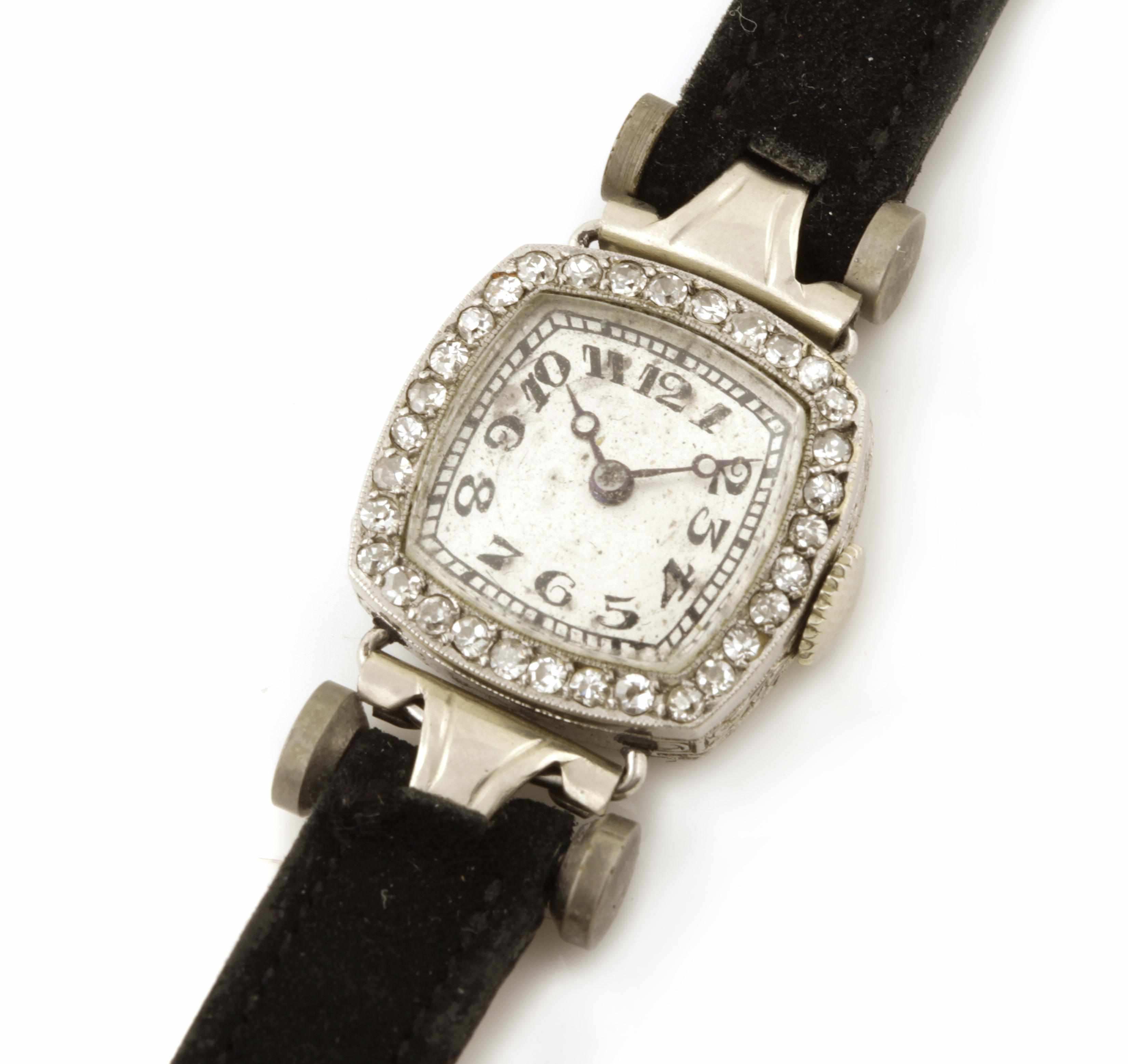 Appraisal: A diamond bezel platinum and k gold case black strapped