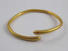 Appraisal: A yellow metal tests high carat gold bangle possibly th